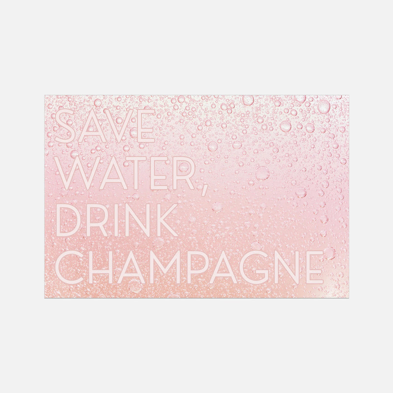 A rectangular decorative sign or print with the phrase “SAVE WATER, DRINK CHAMPAGNE” in large white letters over a pink background with a champagne-bubble pattern, shown on a light gray background.