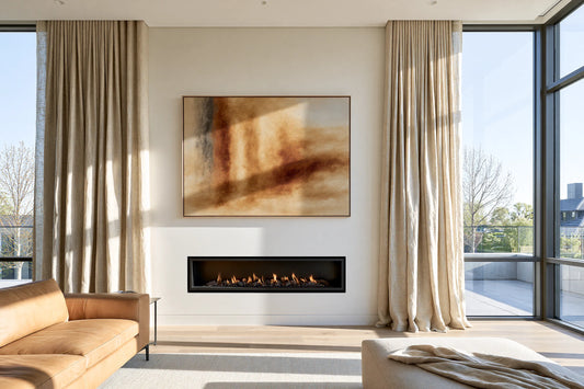 FRAMZE luxury earthy abstract canvas artwork styled above a modern flush-mount linear gas fireplace in a bright Australian living room with light timber floors and elegant oatmeal linen curtains catching winter sunlight