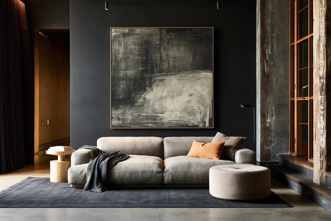 Oversized square abstract canvas wall art hung above a linen sofa in a moody modern Australian living room — FRAMZE