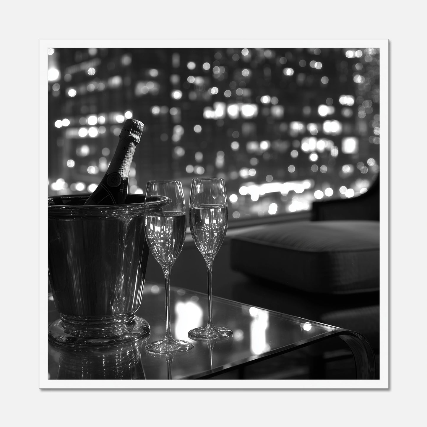 White framed wall art of two champagne glasses and a bottle in an ice bucket on a table with a cityscape in the background.