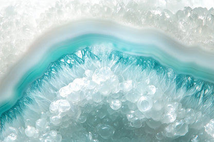 A close-up of a geode-like crystal formation with layered bands of white, turquoise blue, and clear faceted crystals.