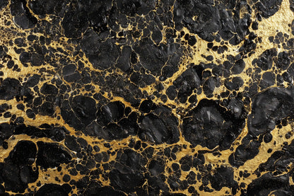 Black and gold marbled pattern with organic black veining over a metallic gold background.