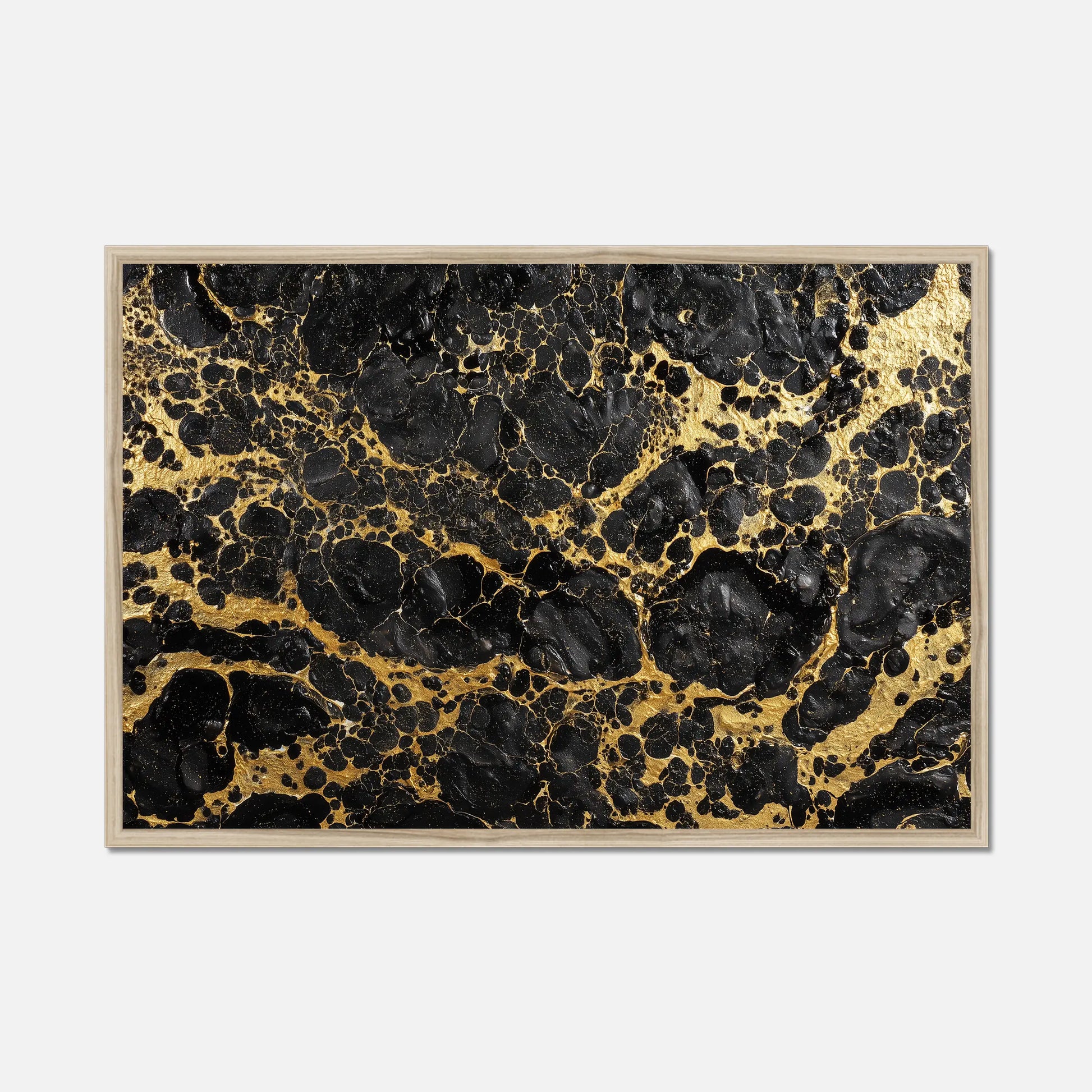 Framed artwork with black and gold abstract pattern on a white background