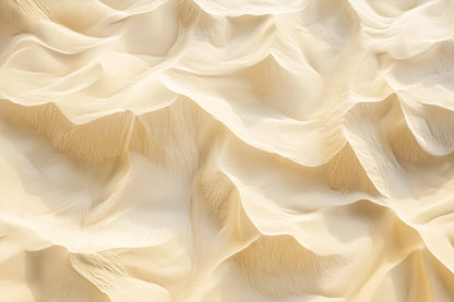A close-up of draped, ruffled fabric in a warm ivory or cream tone, filling the entire frame.