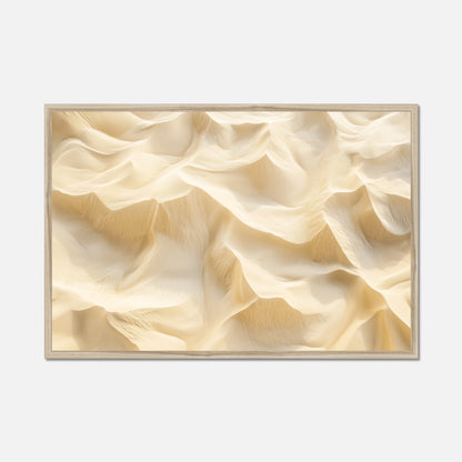 A framed abstract art print featuring a textured, wavy dune-like pattern in warm cream and beige tones, set against a light gray background.