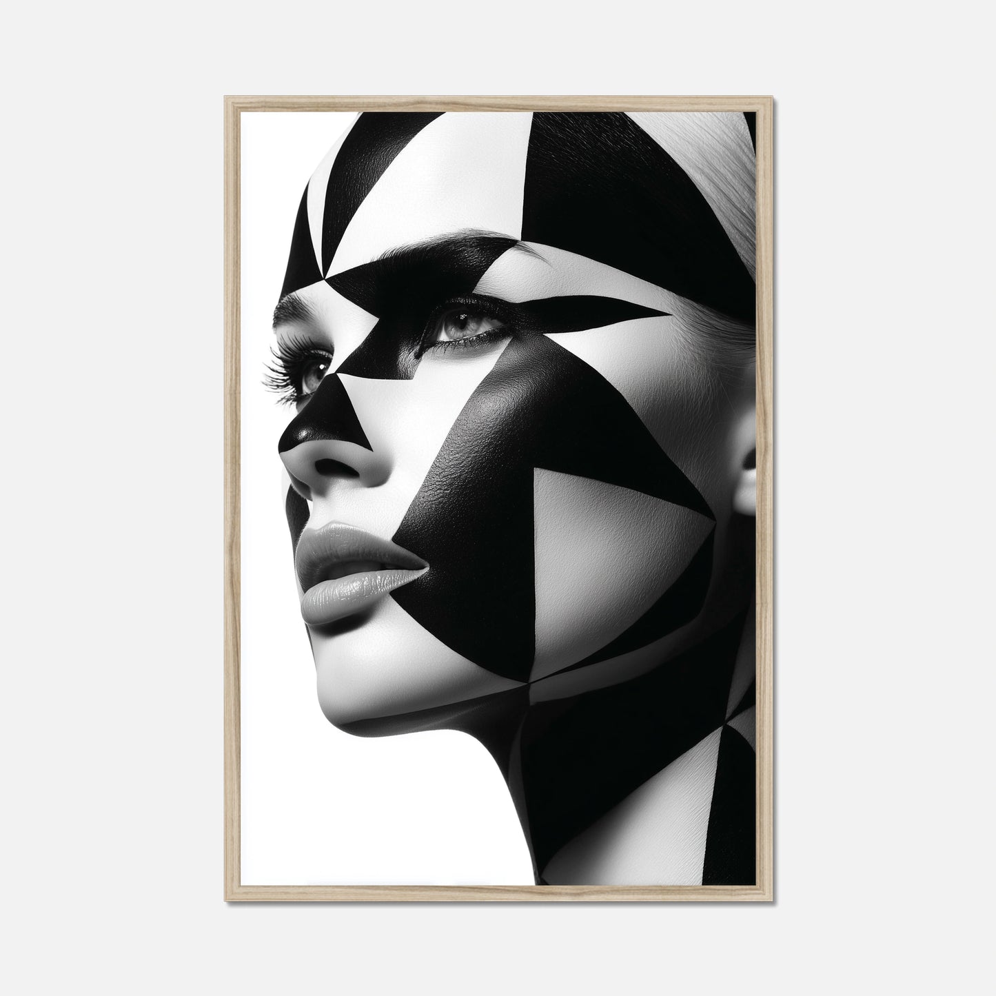 Natural oak framed close-up portrait of a woman's face with dramatic black and white geometric face paint and makeup, shown against a plain white background.