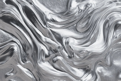 A close-up of a metallic silver surface with a fluid, marbled texture and reflective highlights.
