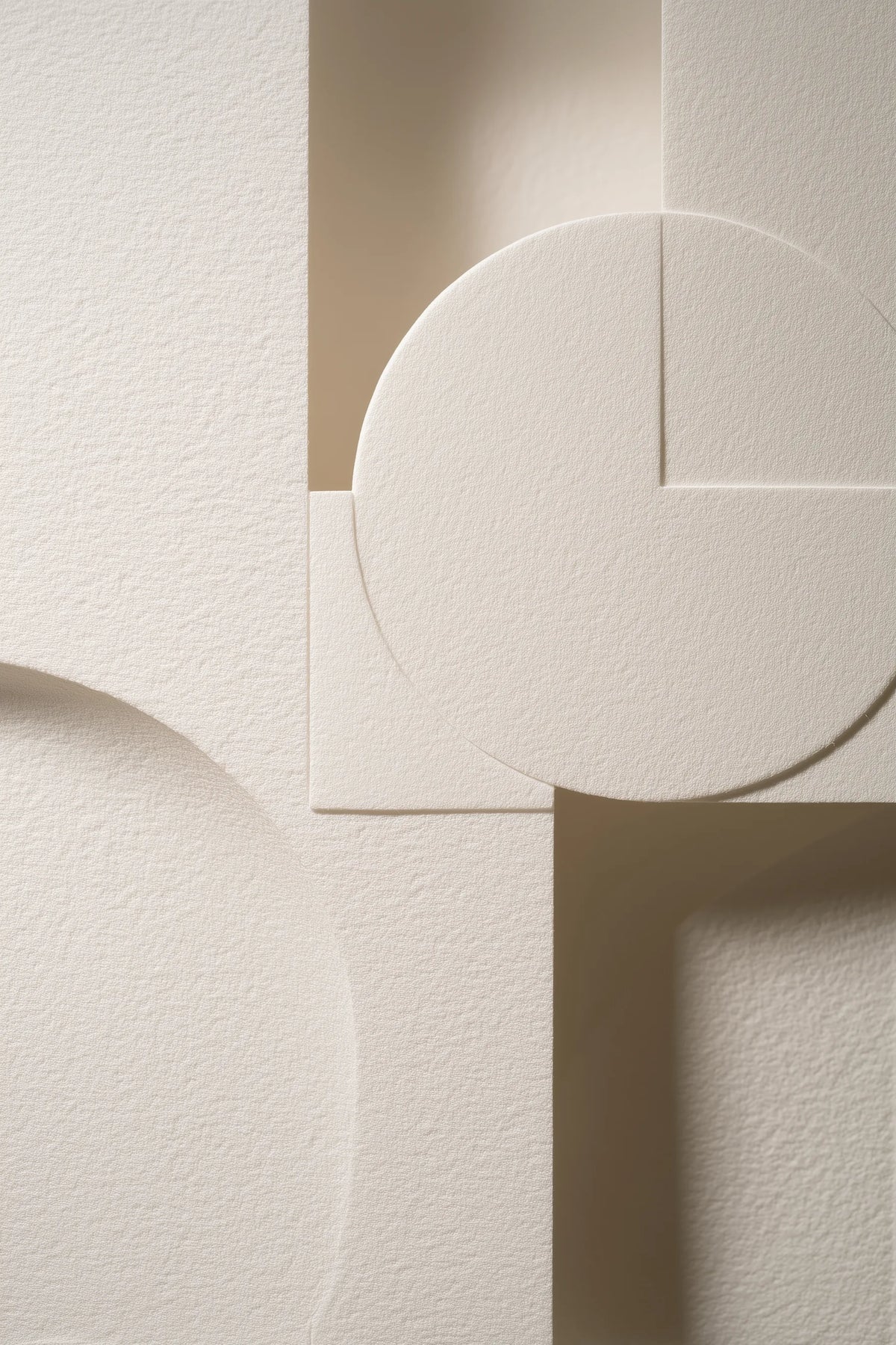 Abstract geometric wall art featuring textured off-white paper shapes with circular, square, and rectangular forms in soft beige and cream tones.