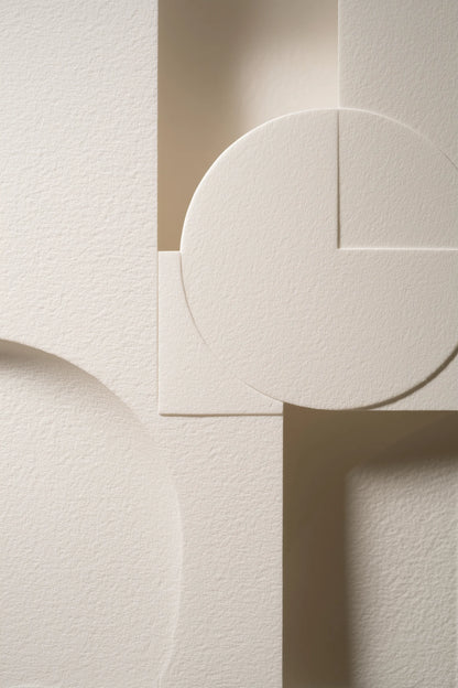 Abstract geometric wall art featuring textured off-white paper shapes with circular, square, and rectangular forms in soft beige and cream tones.