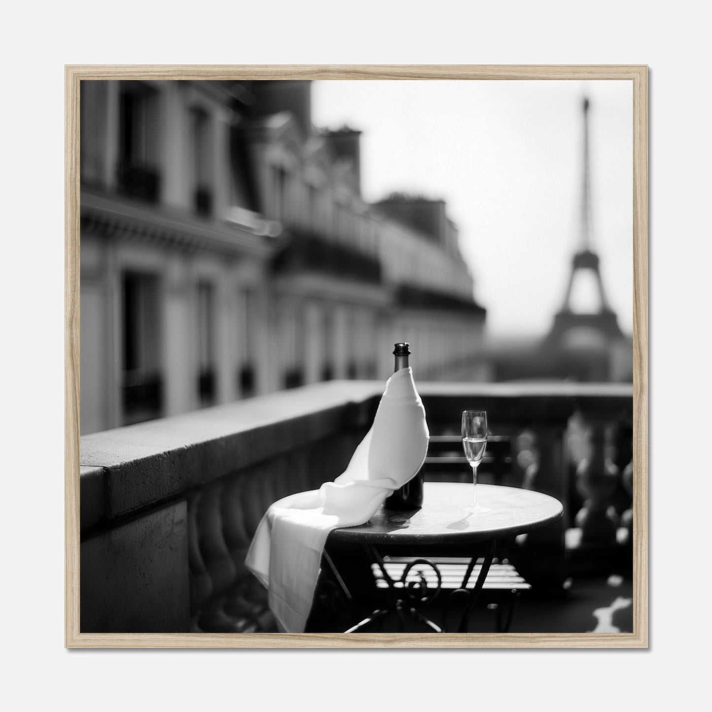 Natural oak framed bottle and wine glass on a table with the Eiffel Tower in the background