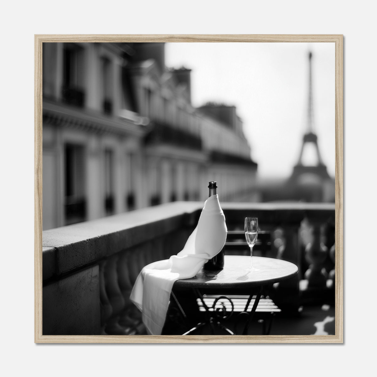 Natural oak framed bottle and wine glass on a table with the Eiffel Tower in the background