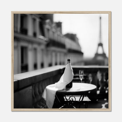 Natural oak framed bottle and wine glass on a table with the Eiffel Tower in the background