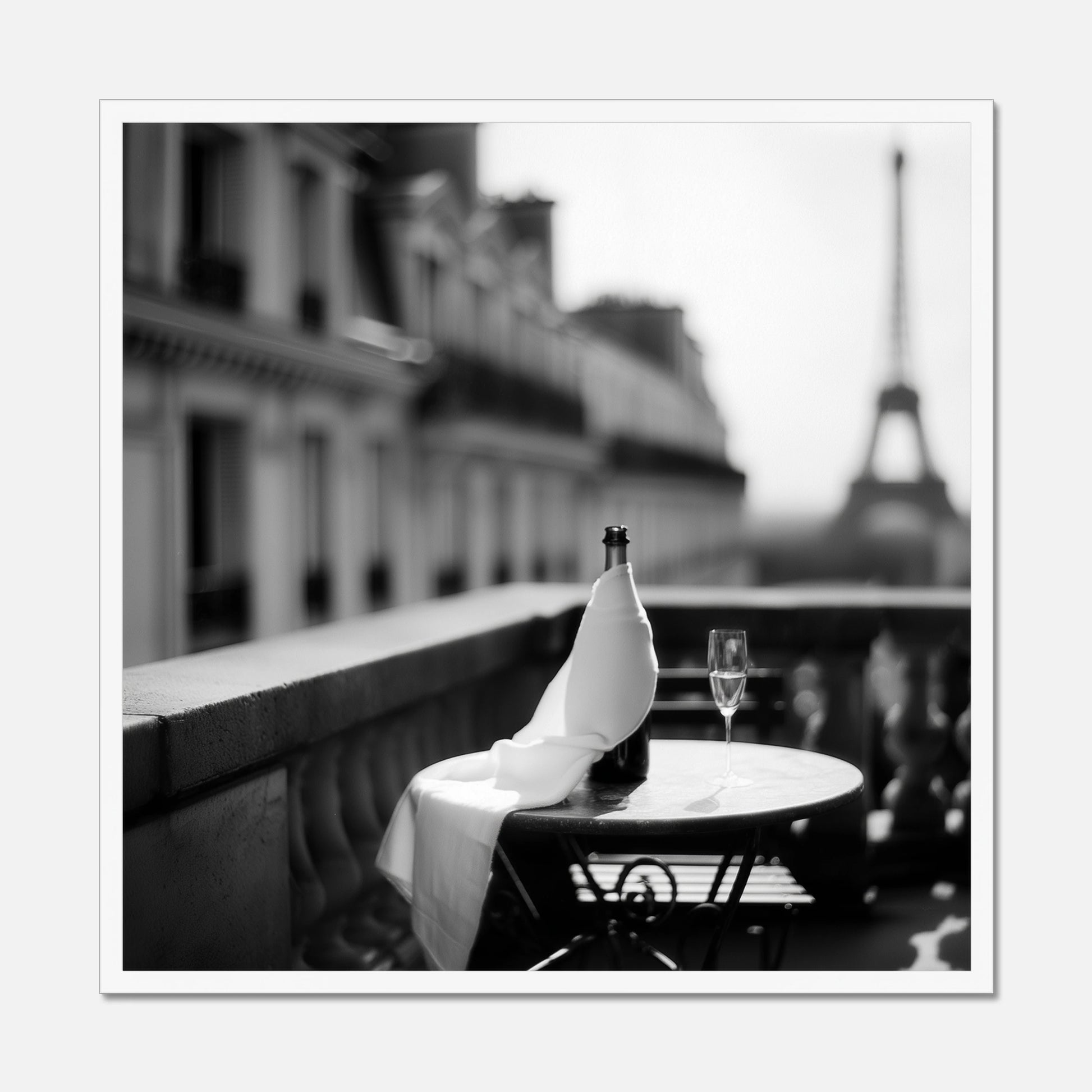 White framed bottle and wine glass on a table with the Eiffel Tower in the background
