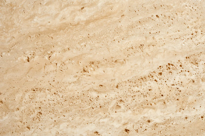 Beige travertine stone texture with natural brown veining and porous mottling throughout.