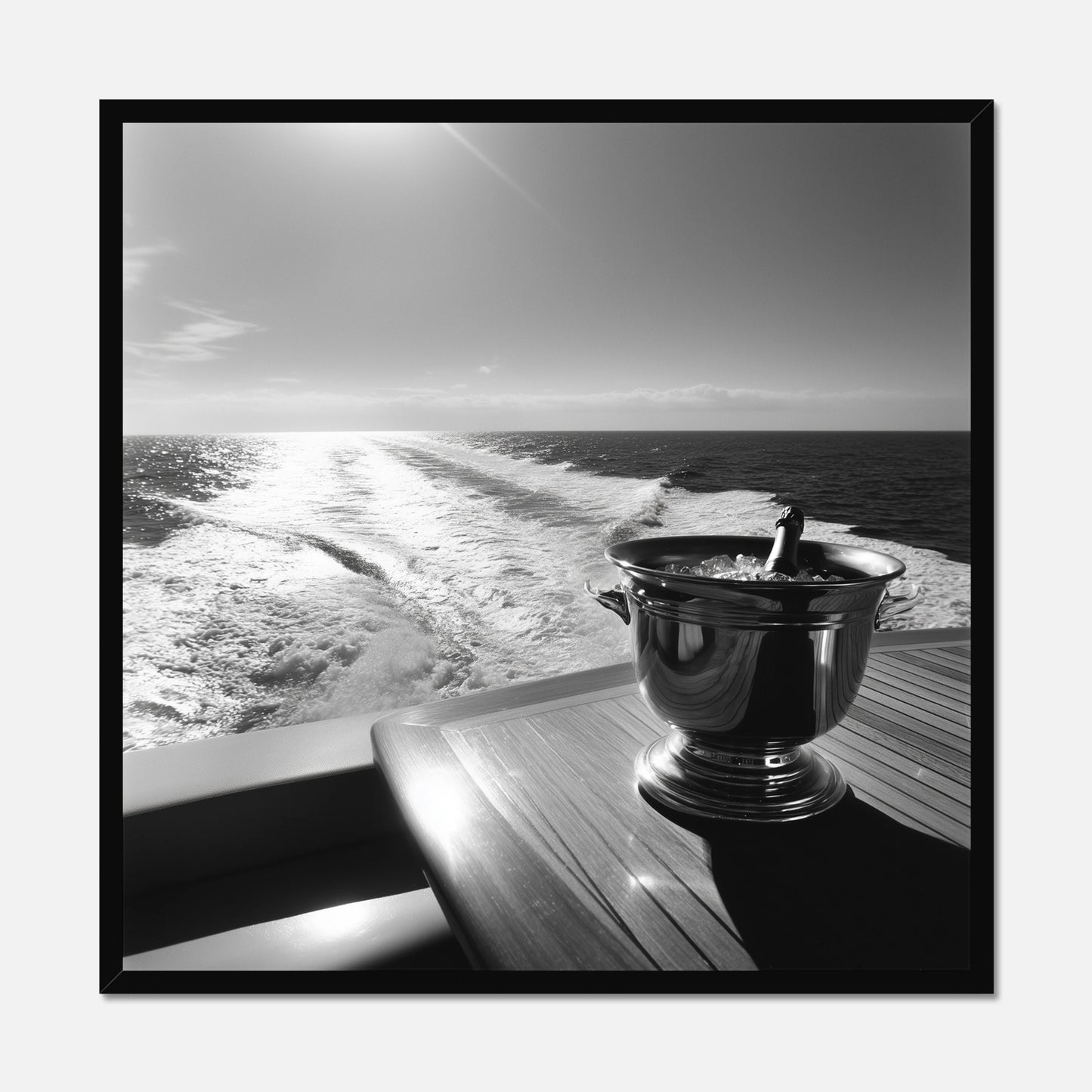Black framed print of the back of a yacht with a wooden table and champagne bucket
