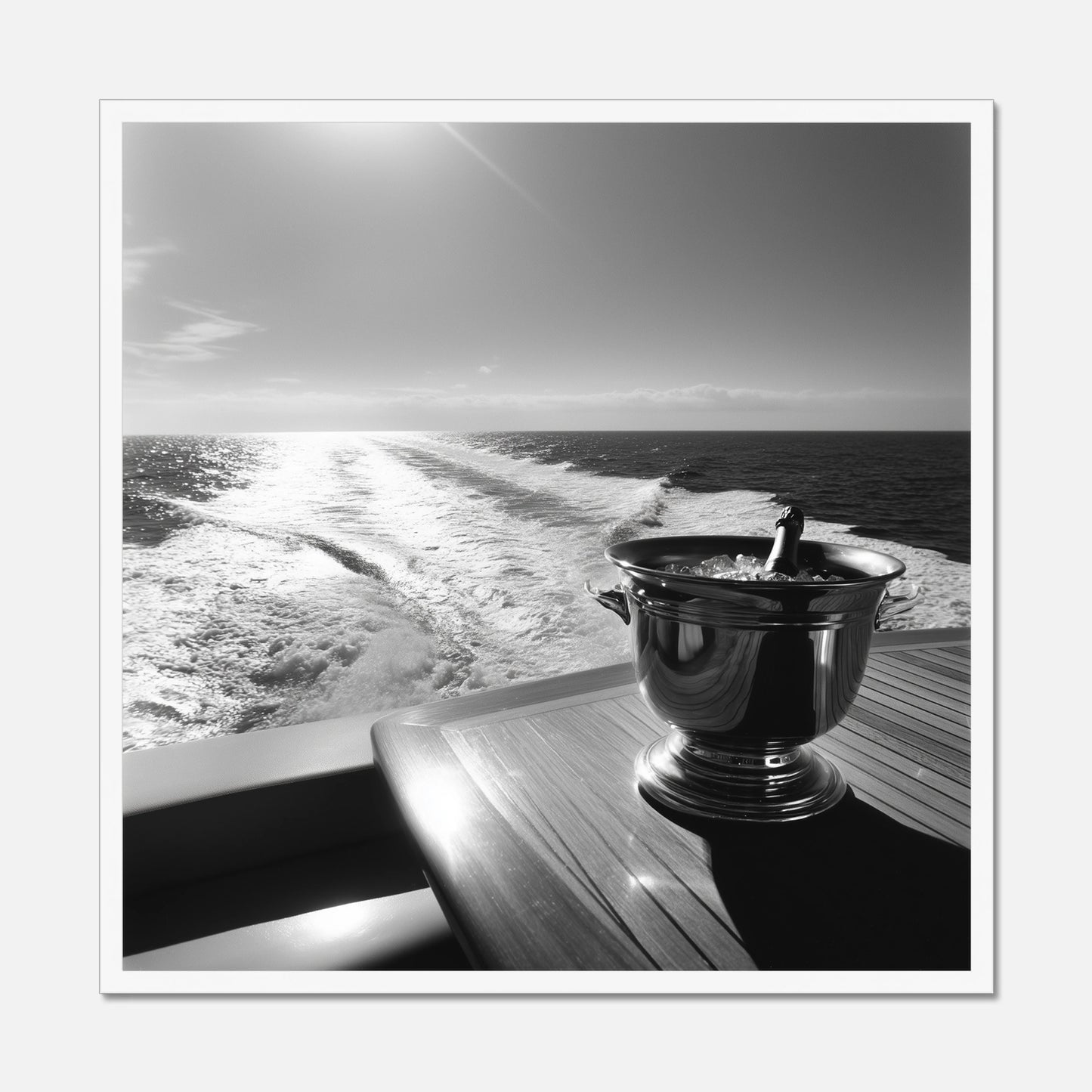 White framed print of the back of a yacht with a wooden table and champagne bucket