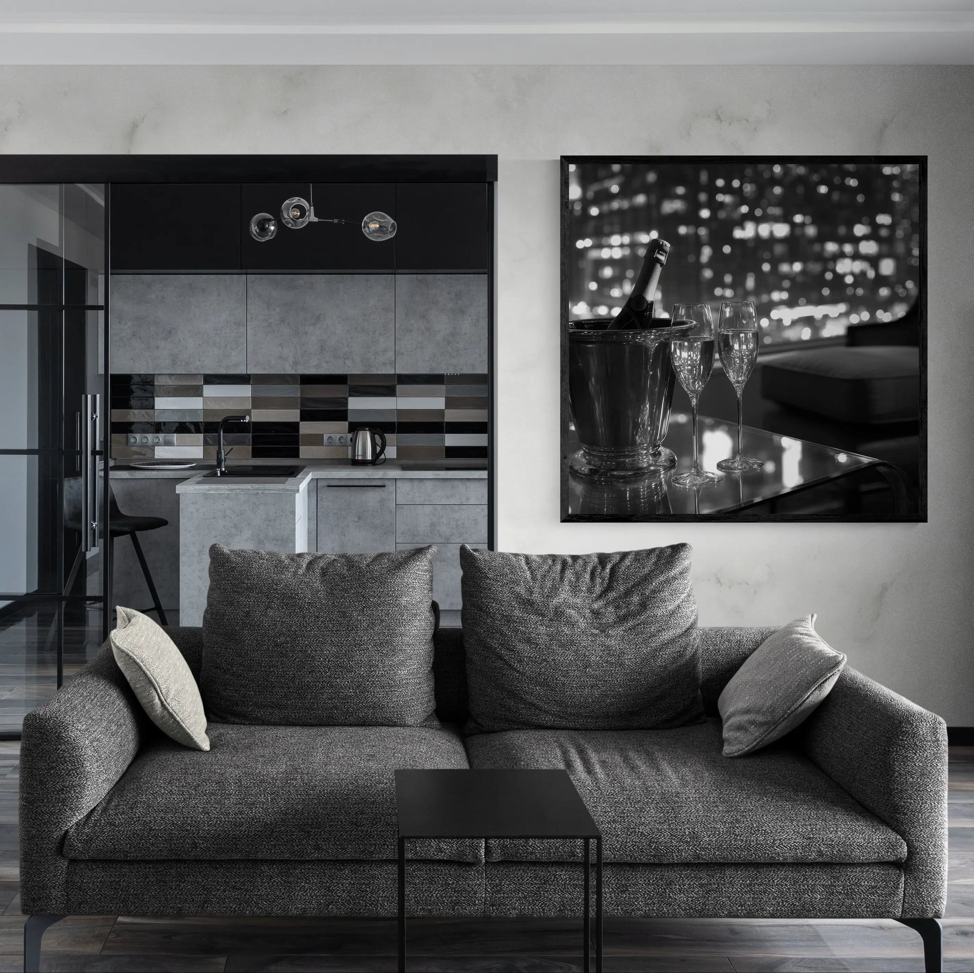 Modern living room with a gray sofa, kitchen in the background, and a decorative wall piece.