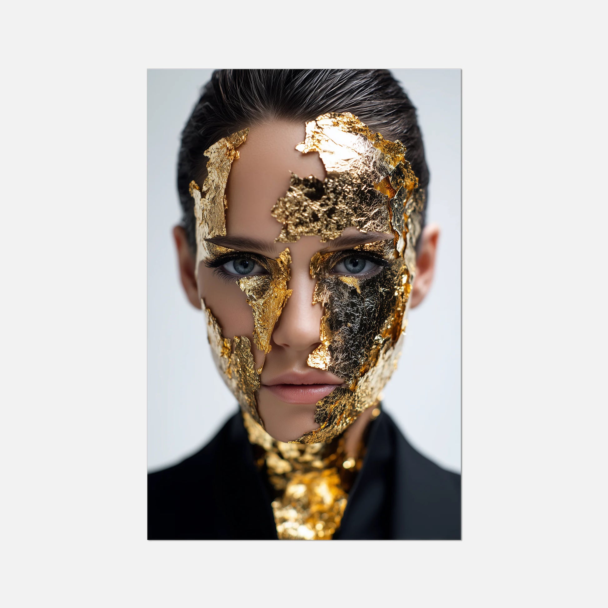 Person with gold leaf on face against a light gray background