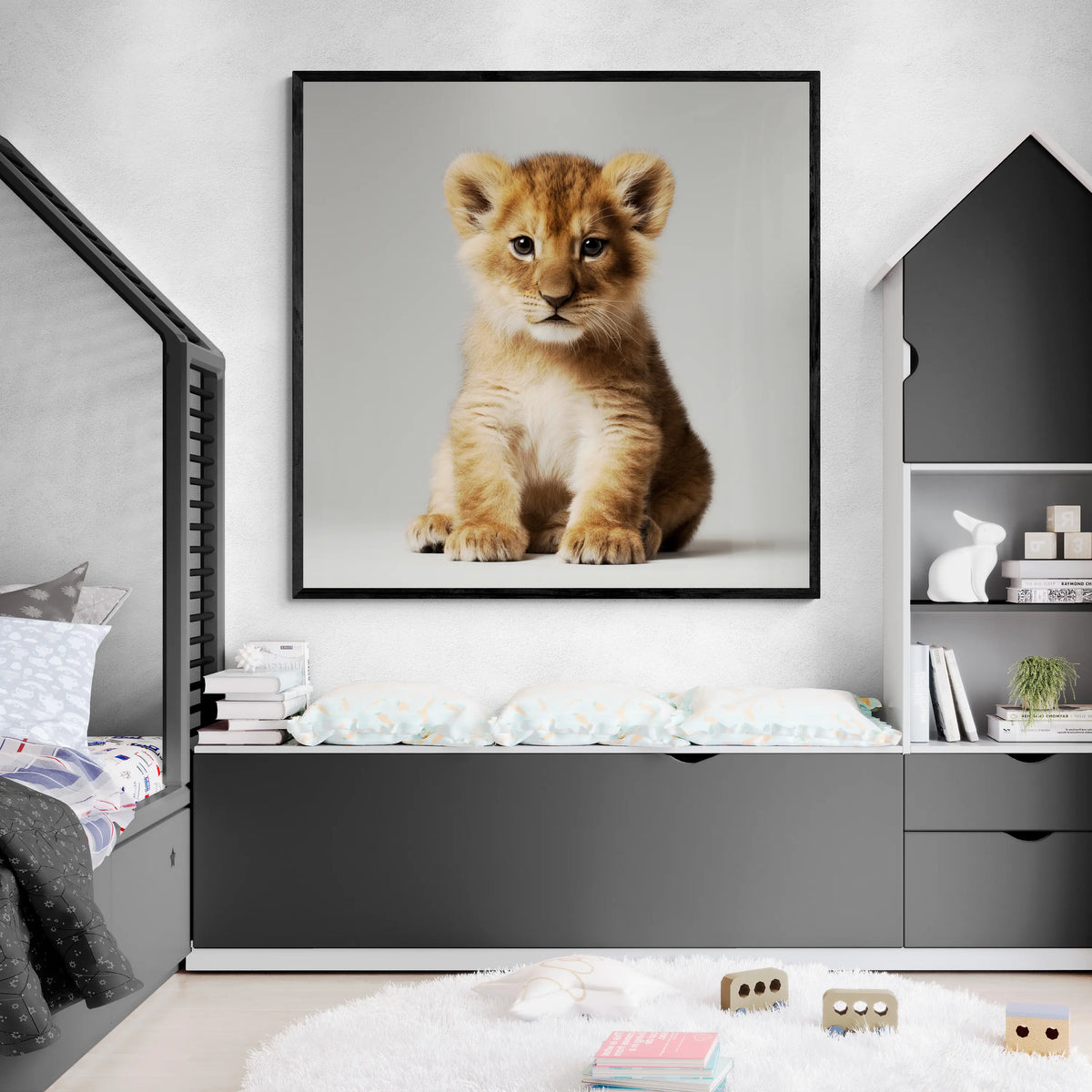 Framed picture of a lion cub on a wall in a child's bedroom.
