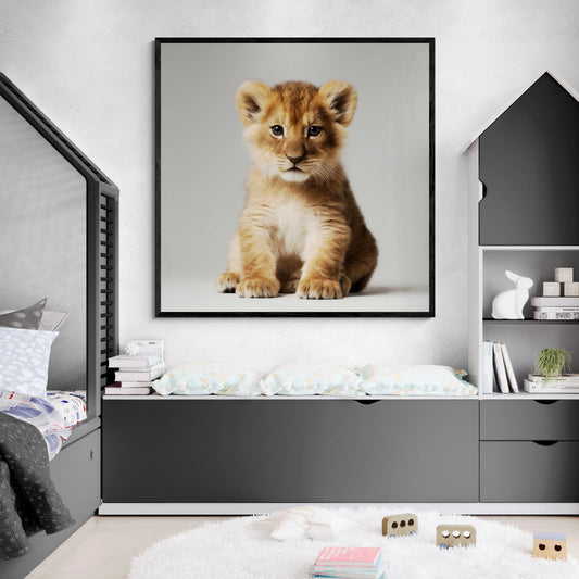 Framed picture of a lion cub on a wall in a child's bedroom.