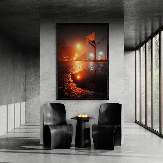Modern interior with two chairs and a small table, featuring a large framed photograph of a basketball game at night.