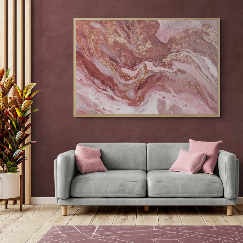 Living room with a gray sofa, pink cushions, and a abstract art piece on the wall.