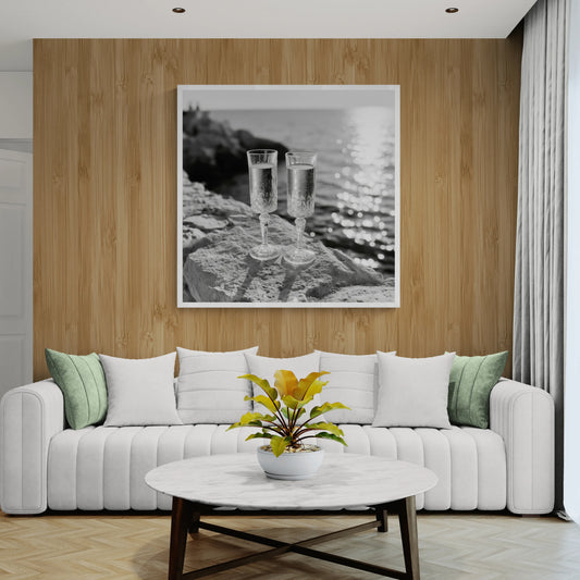 A modern living room with cream sofa, brown wooden wall with a stunning wall art of two champagne flutes