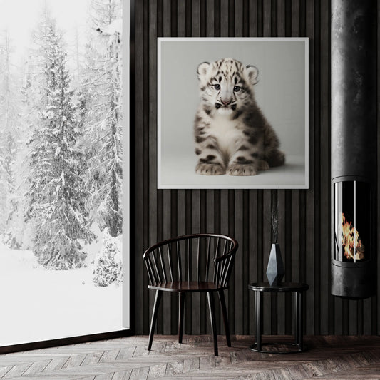 Modern interior with a snowy landscape view, a chair, and a fireplace with a white framed picture of a snow leopard cub on a gray background