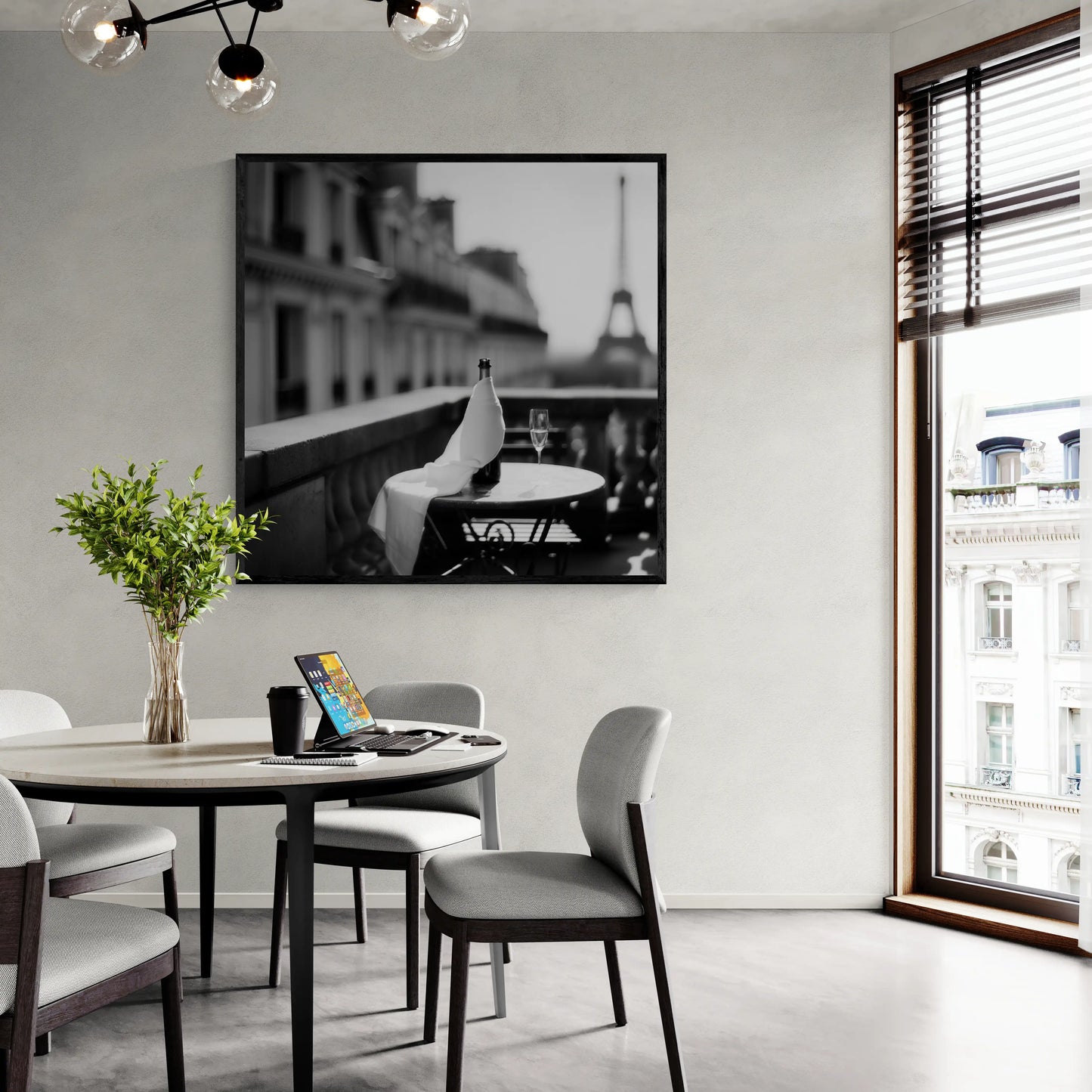 Modern dining room with a round table, chairs, and a large window with a beautiful wall art piece.