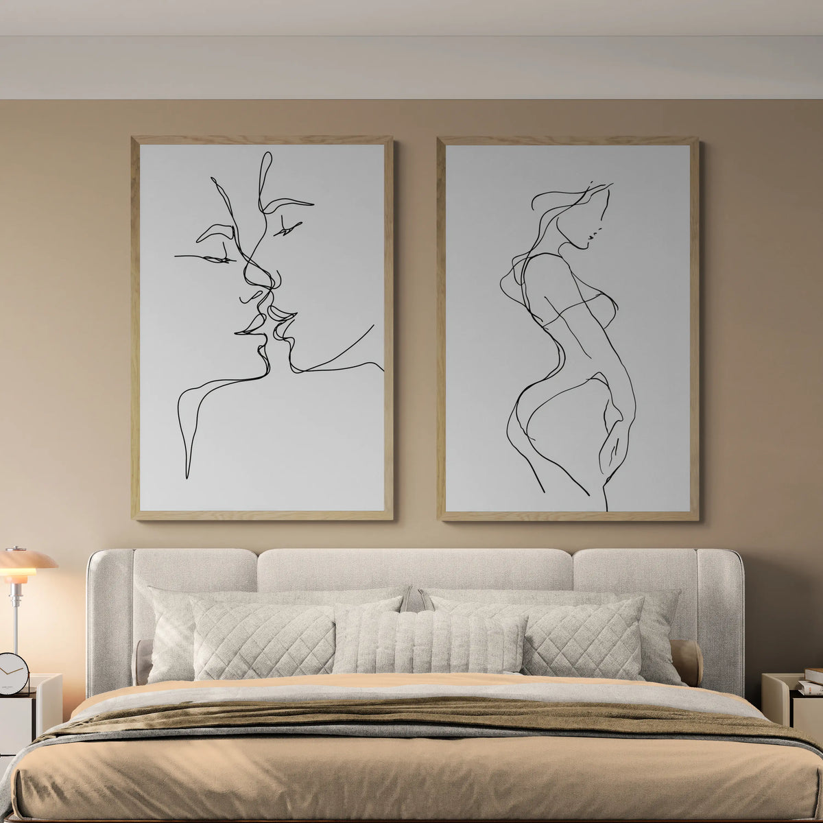 The best bedroom with two thin line wall art pieces above a grey bed and beige blankets