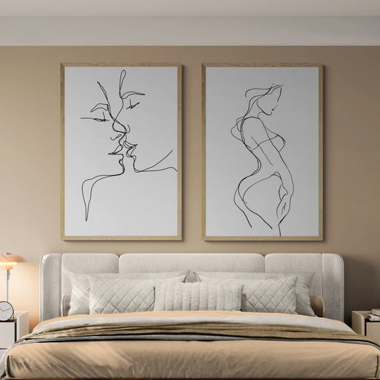 The best bedroom with two thin line wall art pieces above a grey bed and beige blankets