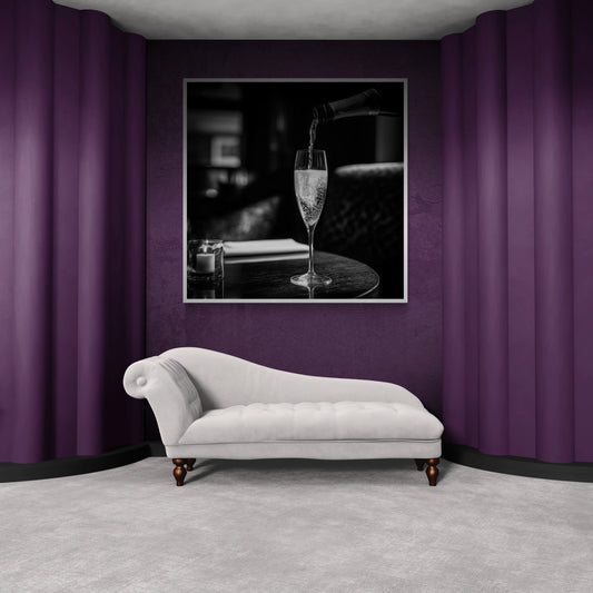 White chaise lounge in a room with purple walls and a framed picture of a glass of champagne.