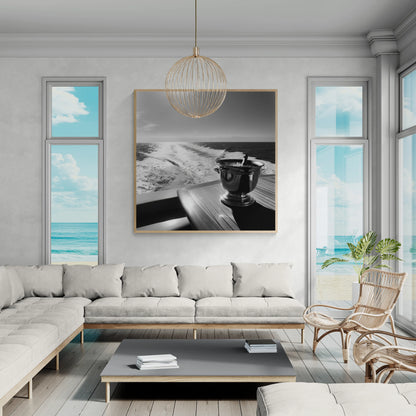 Modern living room with a gray sectional sofa, coffee table, and decorative wall art.