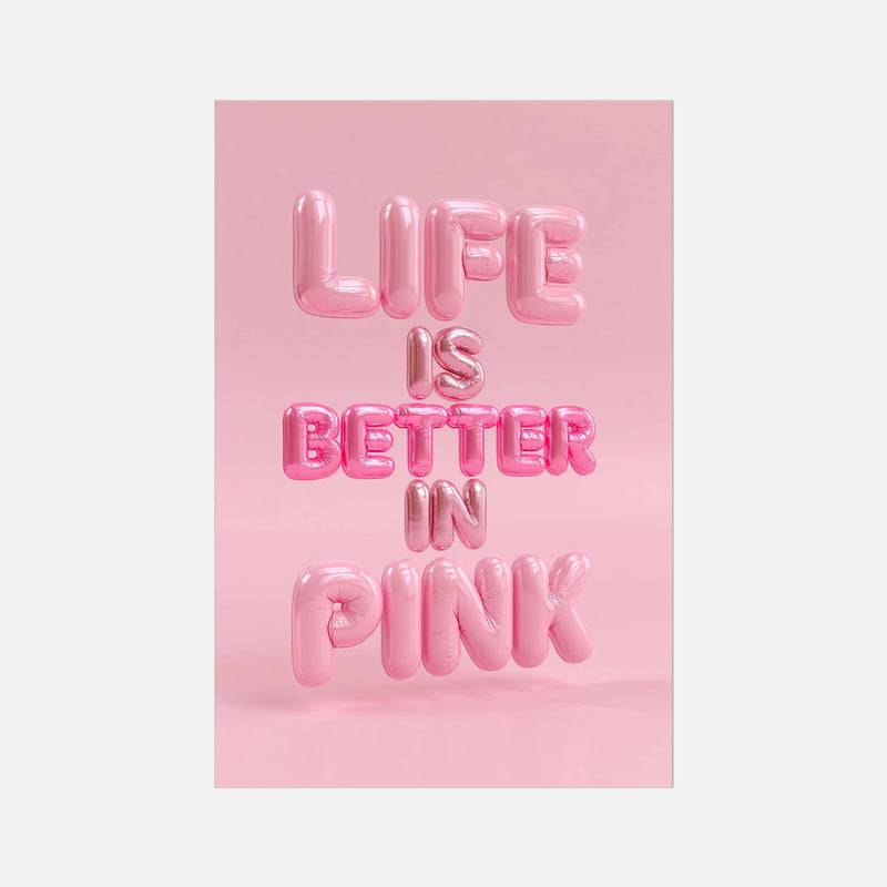 A vertical art print featuring the phrase 'LIFE IS BETTER IN PINK' in glossy, 3D pink balloon lettering against a solid pink background, shown centered on a light gray backdrop.