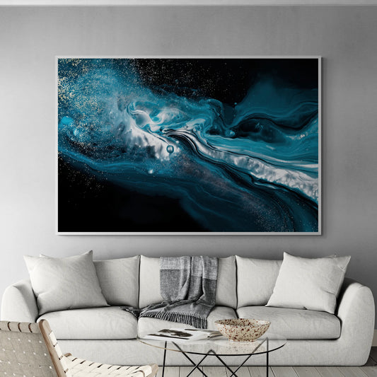 A large framed abstract wall art print featuring swirling teal, blue, black, and white marbled patterns with subtle gold speckles, displayed above a light gray sofa in a modern living room setting.
